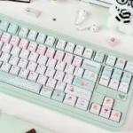 Whimsical PBT dye-sub bear keycaps from the Honey Blossom set, featuring charming bears, delicate flowers, and honey in soft hues.