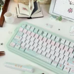 Close-up of a whimsical PBT dye-sub bear keycap from the Honey Blossom set, highlighting the charming bear and delicate flower design in soft hues.