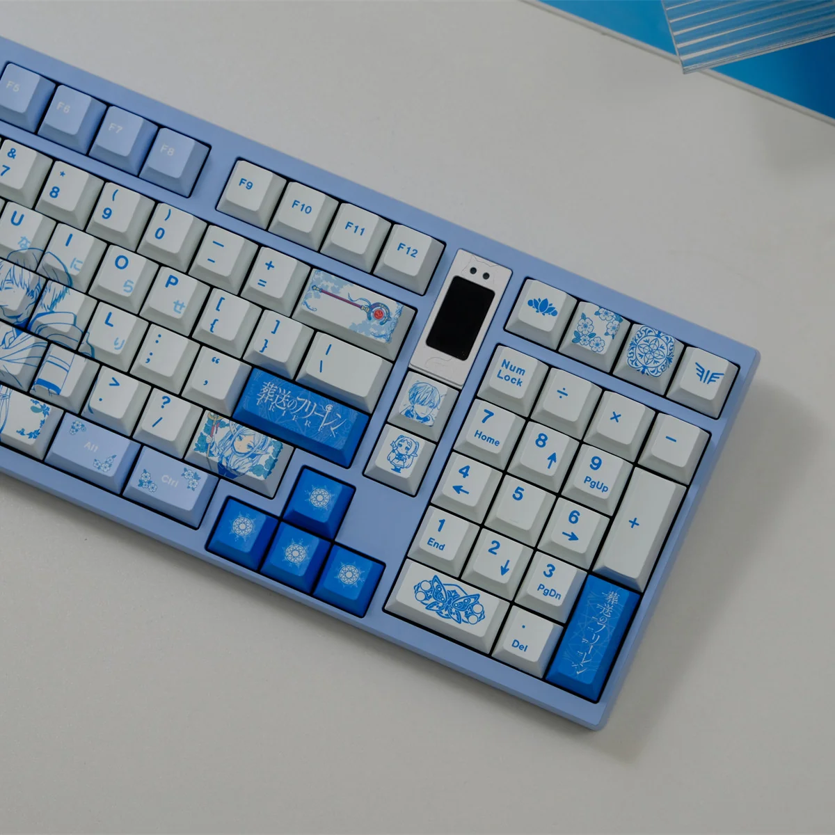 A close-up view of the Frieren: Beyond Journey's End keycap set, showcasing vibrant, meticulously crafted iconic character designs and symbols.
