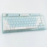 Blue Kitten Crystal Jelly MAO Keycap showcasing its translucent, iridescent design. This whimsical keycap features a playful cat-ear shape.