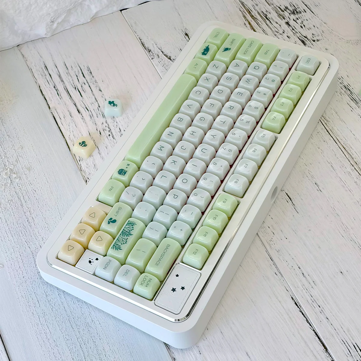 A collection of Jelly Green PC keycaps in MAO profile, showcasing their vibrant botanical journey design and smooth jade-like finish from various angles.