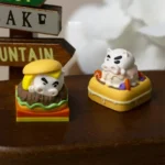 Collectible Crayon Shin-Chan Buriburizaemon artisan keycaps, showcasing whimsical burger and waffle designs from multiple playful angles.