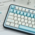Butterfly Lovers Keycaps from various angles, revealing their shimmering iridescent blue-white pearlescent finish and delicate butterfly artisty.