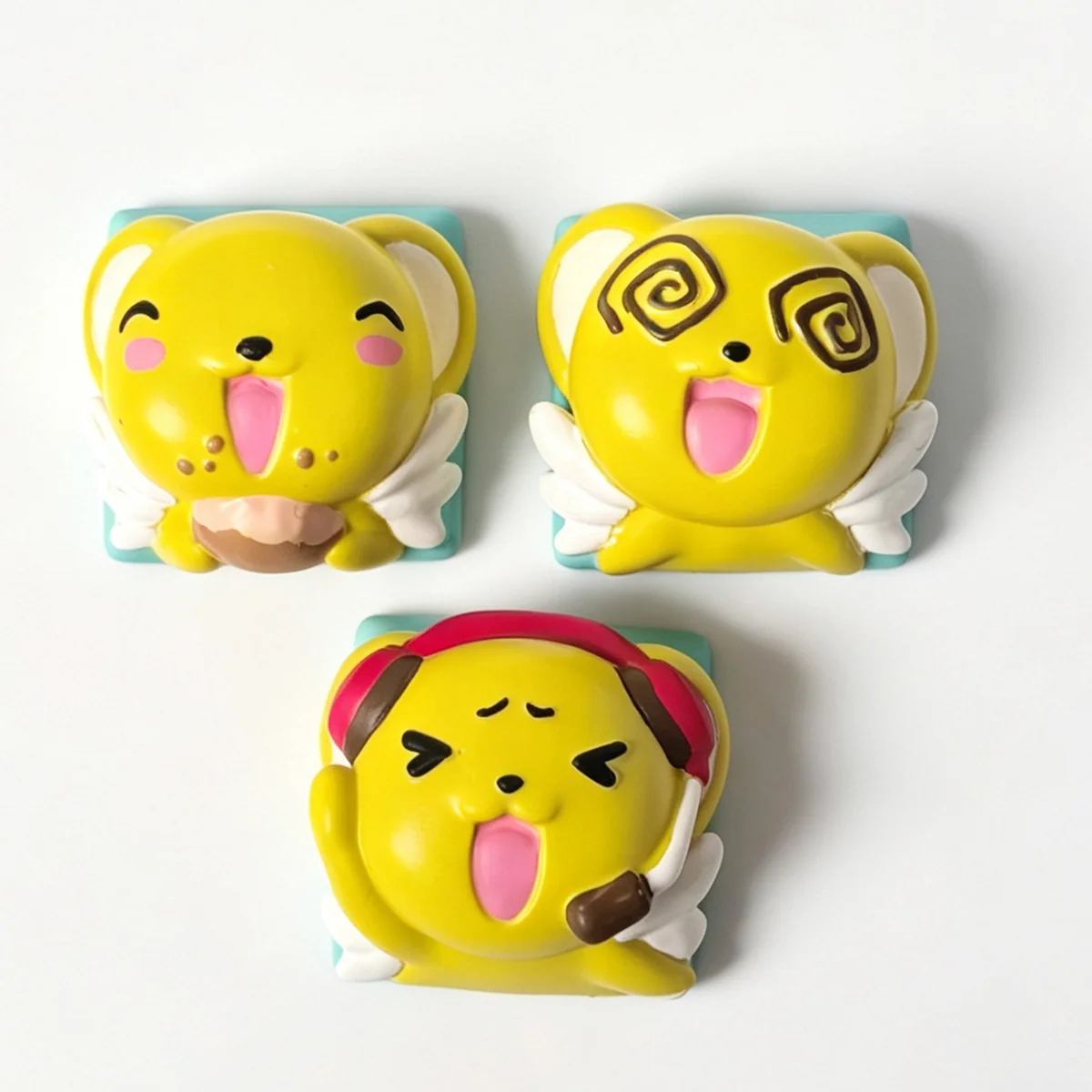 Close-up of the handcrafted Cardcaptor Sakura Cerberus resin keycap, revealing the vibrant, intricately sculpted Cerberus character from a unique angle.