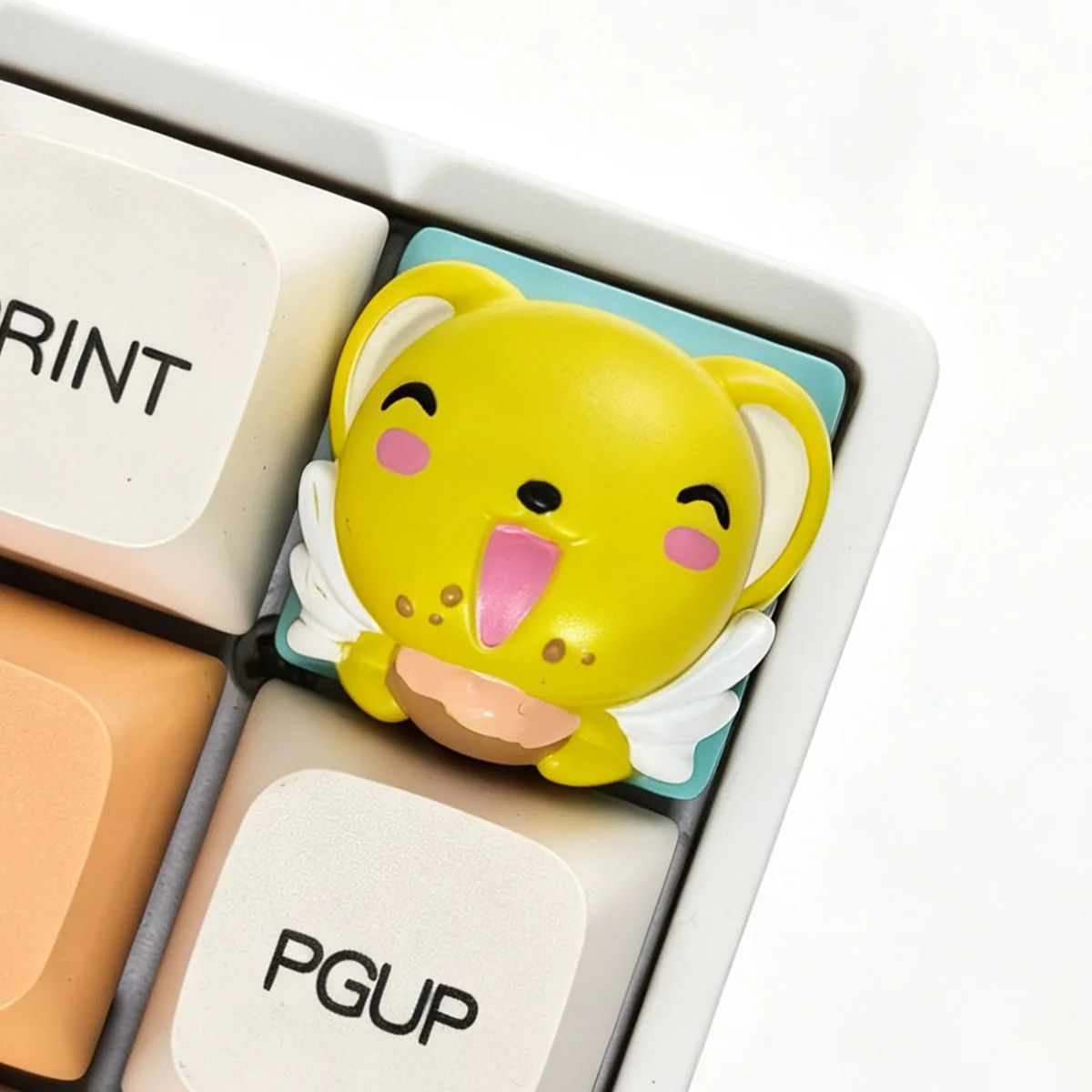 Whimsical handcrafted Cardcaptor Sakura Cerberus resin keycap, vibrant and intricately sculpted, viewed from a unique angle to highlight its artistic details.