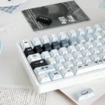 Product gallery showing various whimsical Cat Baker PBT Dye-Sub Keycaps, featuring playful feline chefs in warm kitchen scenes with intricate details.