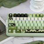 Close-up of exquisite handcrafted Night Astrology ceramic keycaps, showcasing their mystical deep green glaze and celestial night sky.