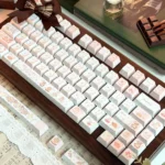 Charming Cat & Spring PBT Keycap Set featuring whimsical cats and pastel spring flowers. View the vibrant dye-sub PBT keycaps from various artistic.