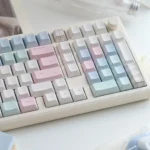 Close-up of whimsical Cheese Bunny Keycaps showing their durable PBT+PC MOA profile and vibrant pastel cartoon designs from multiple angles.