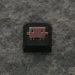 A detailed close-up of the Claude AI & Mascot Clawd keycap, showcasing its intricate zinc alloy craftsmanship and premium metallic.