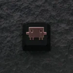 Detailed zinc alloy Claude AI & Mascot Clawd keycap with metallic finish, shown from a unique angle. A premium Claude AI keycap.