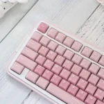Vibrant red and pink CSA Strawberry Jelly Pudding keycaps, showcasing their translucent, ergonomic profile and playful, food-inspired aesthetic.