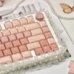 Liquid Foundation CSA keycaps from various angles. Showcases cosmetic dessert themes, soft pastels, and ergonomic spherical design.