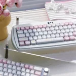 A whimsical Fairy Garden keycap set, showcasing its unique storybook illustrations and soft pastel hues from a playful, detailed side profile.