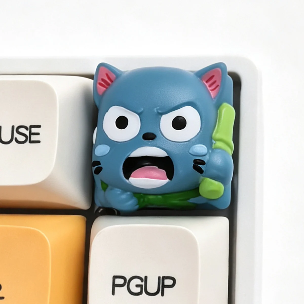 A vibrant, handcrafted Fairy Tail Happy resin keycap, showcasing its intricate 3D design and playful details from a unique side angle.