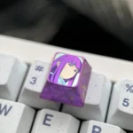 A gallery of views of the premium Fern titanium artisan keycap, showcasing vibrant character art on polished metal, a magical collectible.