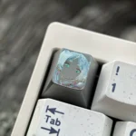 Artistic Frieren Hand-Carved Titanium Artisan Keycap, displaying delicate etched lines of Frieren's silhouette on matte titanium.
