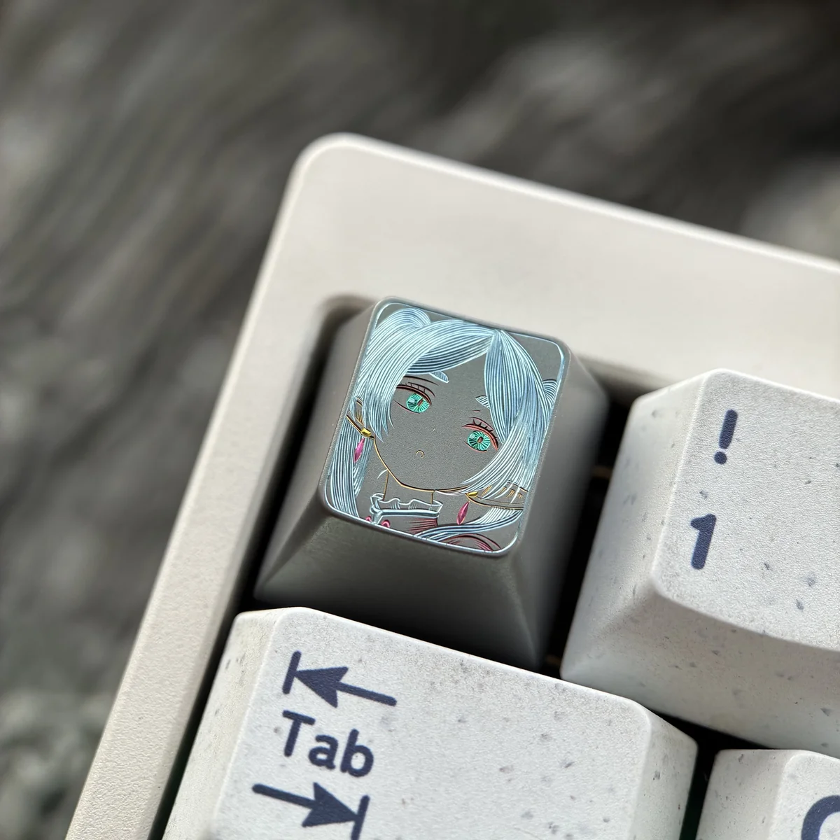 Artistic Frieren Hand-Carved Titanium Artisan Keycap, displaying delicate etched lines of Frieren's silhouette on matte titanium.