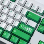 A collection of vibrant green Mischief Keycaps shown from various angles, highlighting the playful custom legends and durable double-shot ABS.