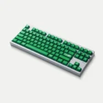 A close-up view of the vibrant green Mischief Keycaps, showcasing their playful custom legends and durable double-shot ABS construction from a unique angle.