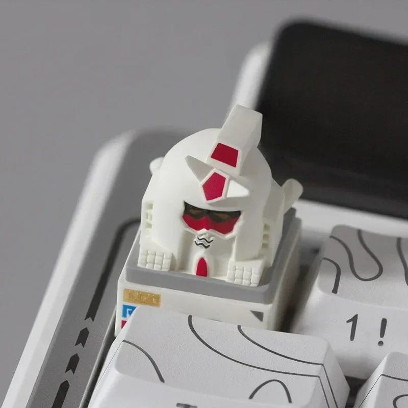 A unique, abstract backlit RX-78-2 Gundam artisan keycap, showcasing a playful monkey-like interpretation for custom mechanical keyboards.