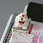 A close-up view of the unique Abstract Backlit RX-78-2 Gundam Artisan Keycap ESC, showcasing its playful 'monkey' interpretation and vibrant backlight design.