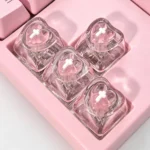 A collection of vibrant, translucent luminous heart keycaps for mechanical keyboards, showcasing their polished mirror-like finish from various angles.