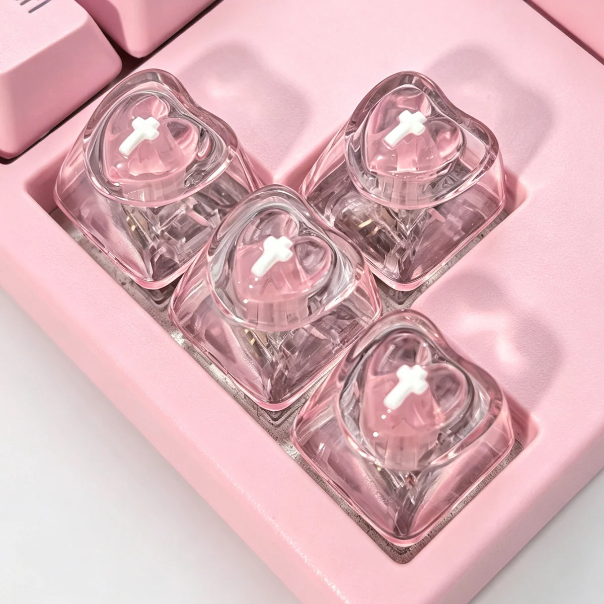 A collection of vibrant, translucent luminous heart keycaps for mechanical keyboards, showcasing their polished mirror-like finish from various angles.