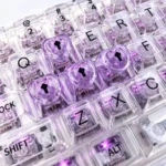 A collection of vibrant, translucent heart keycaps for mechanical keyboards, showcasing their luminous glow and polished mirror finish from various angles.
