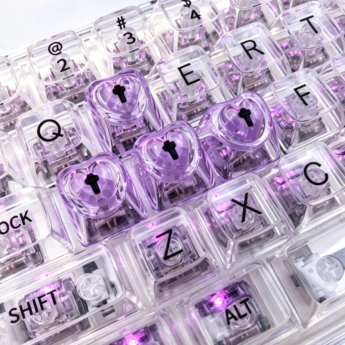 A collection of vibrant, translucent heart keycaps for mechanical keyboards, showcasing their luminous glow and polished mirror finish from various angles.