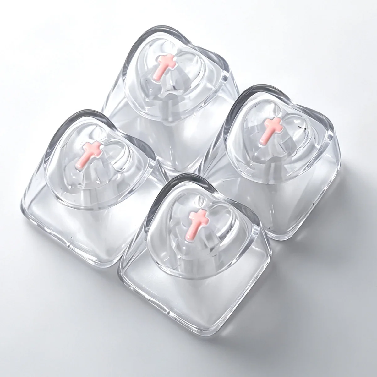 Four vibrant pink translucent heart keycaps for mechanical keyboards, featuring a luminous and polished finish that glows with personalized charm.