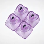 Close-up of four luminous white translucent heart keycaps, exquisitely polished, casting a soft glow for a personalized mechanical keyboard.