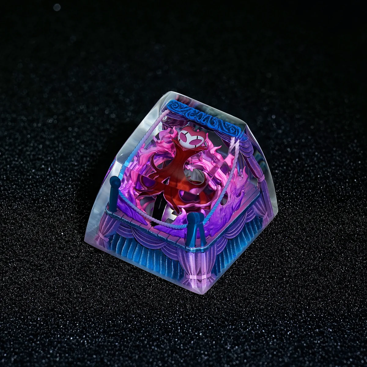 Artisan Hollow Knight Troupe Master Grimm Keycap, intricately detailed from a striking angle, showcasing vibrant transparent resin and premium SA profile.