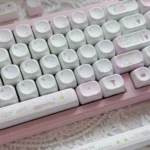 Adorable pink MOA Ice Cream Shop Keycaps from different angles, featuring whimsical dessert themes. Highlights durable PBT material and charming design.