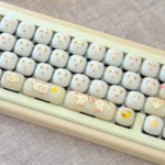 Cat Keycaps Jelly Bun set: Adorable, milky-white, smooth PC keycaps with an ergonomic MOG profile, showcased from various playful angles.