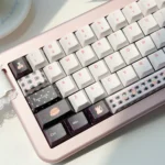 Durable PBT Dye-Sub Cat Keycap Set gallery showing playful, whimsical feline characters celebrating from multiple angles. High-quality cat party keycaps.