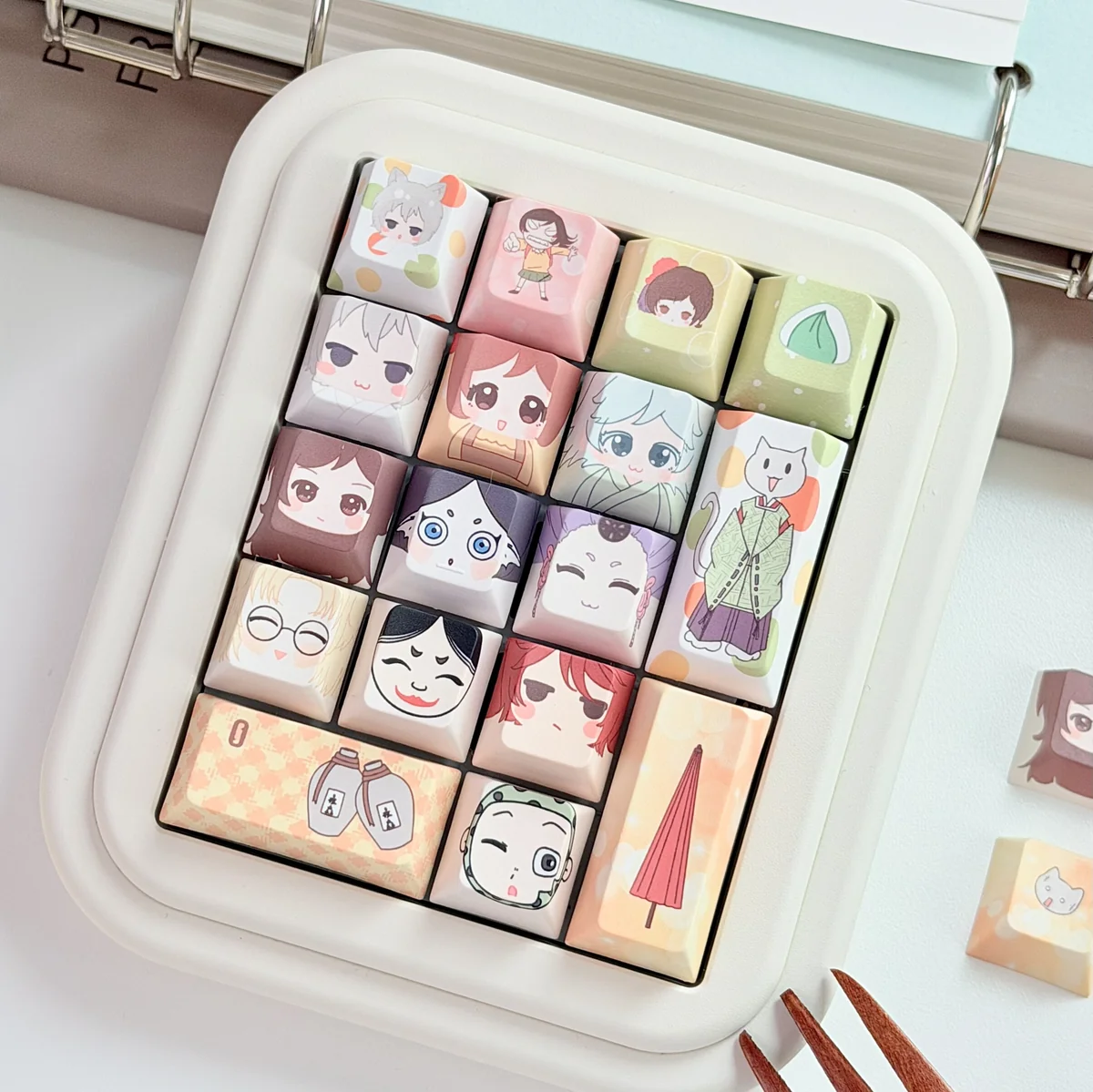 Exclusive Kamisama Kiss PBT keycap set, shown from multiple angles. Features vibrant anime designs capturing the playful Kamisama Kiss aesthetic.