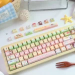 Close-up of the exclusive Kamisama Kiss PBT keycaps, revealing vibrant anime character art and charming, playful design details from a unique angle.