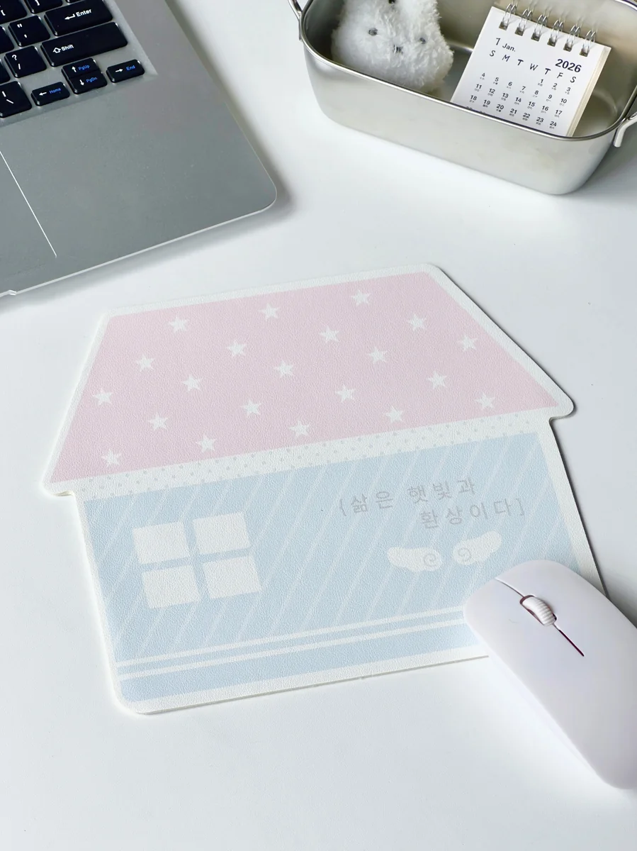 Whimsical Korean house mouse pad from an angled view, highlighting its charming pastel art and anti-slip grip for a playful, stable desk.