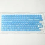 A collection of Gungnir Blue Keycaps from various angles, highlighting the legendary translucent ABS design and its ethereal, modern blue glow.