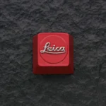 Premium Leica Logo Keycap featuring the striking red iconic logo embossed on sleek zinc alloy, a sophisticated artisan piece for enthusiasts.