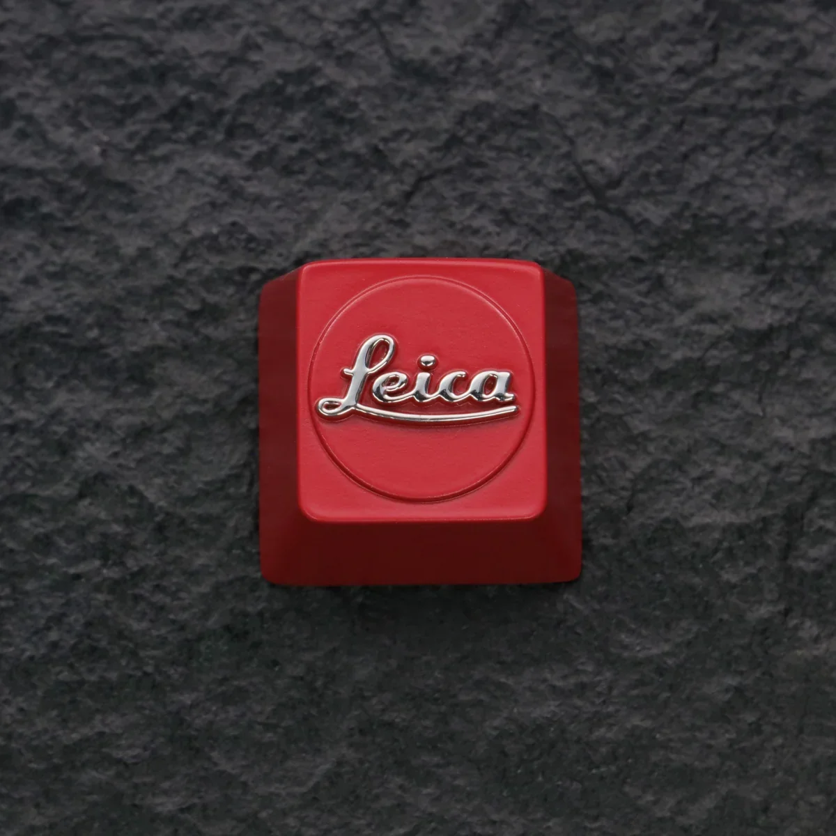 Premium Leica Logo Keycap featuring the striking red iconic logo embossed on sleek zinc alloy, a sophisticated artisan piece for enthusiasts.