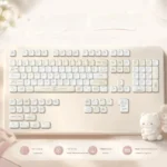 A playful close-up of Lemon Cream Low Shaft PBT dye-sub keycaps in soft pastel yellows and creams, showcasing their minimalist charm.