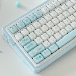 Detailed view of several ergonomic MAO keycaps from the Whimsical Jelly Cat Paradise set, showcasing their playful soft blue and white feline designs.