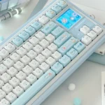 A delightful close-up of the whimsical MAO keycap set, showcasing its unique ergonomic MAO profile and the soft blue jelly cat paradise design.