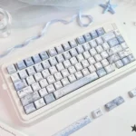 Mist Blue floral PBT dye-sub keycaps, with white patterns on mist blue, displayed from various angles, highlighting tranquil artistic design.