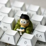 Detailed view of the whimsical Nobita Nobi Keycap, a vibrant custom ESC keycap featuring Doraemon's iconic innocent expression.