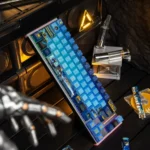 Close-up of an exclusive Overwatch Pharah PBT keycap, showcasing its precise side-engraved art and metallic paint accents from a unique angle.