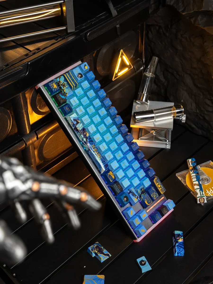 Close-up of an exclusive Overwatch Pharah PBT keycap, showcasing its precise side-engraved art and metallic paint accents from a unique angle.