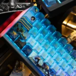 Overwatch Pharah custom PBT keycap showcasing its unique side-engraved art and metallic paint accents from a distinct angle.